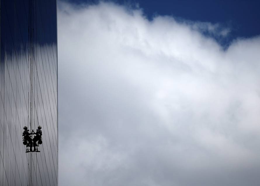 Window cleaner works on the exterior of a hotel outside the 2016 Rio Olympics Park in Rio de Janeiro