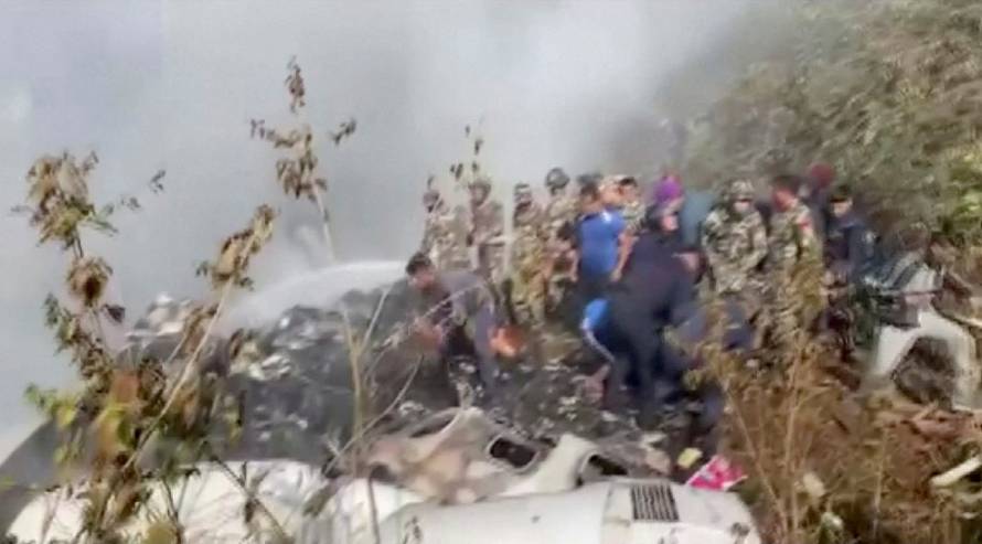 Rescuers work at the site of a plane crash in Pokhara