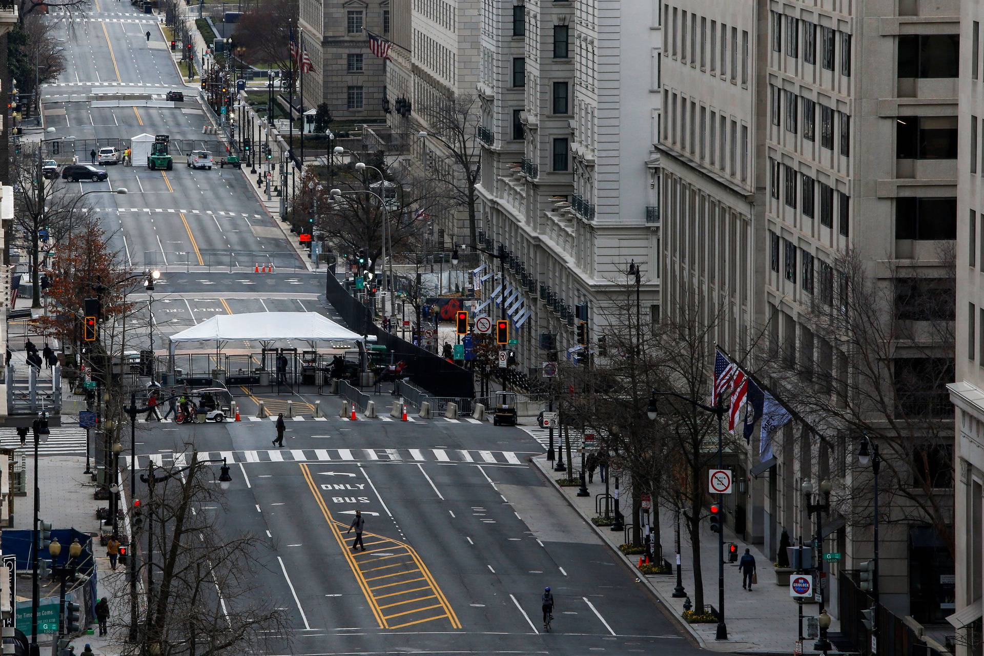People make their way through barricades installed ahead of U.S. President-elect Joe Biden's inauguration, in Washington