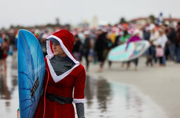 Surfing Santas take to the waves at the annual Christmas Eve event in Cocoa Beach