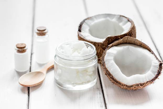 fresh coconut with cosmetic oil in jar on white background mockup