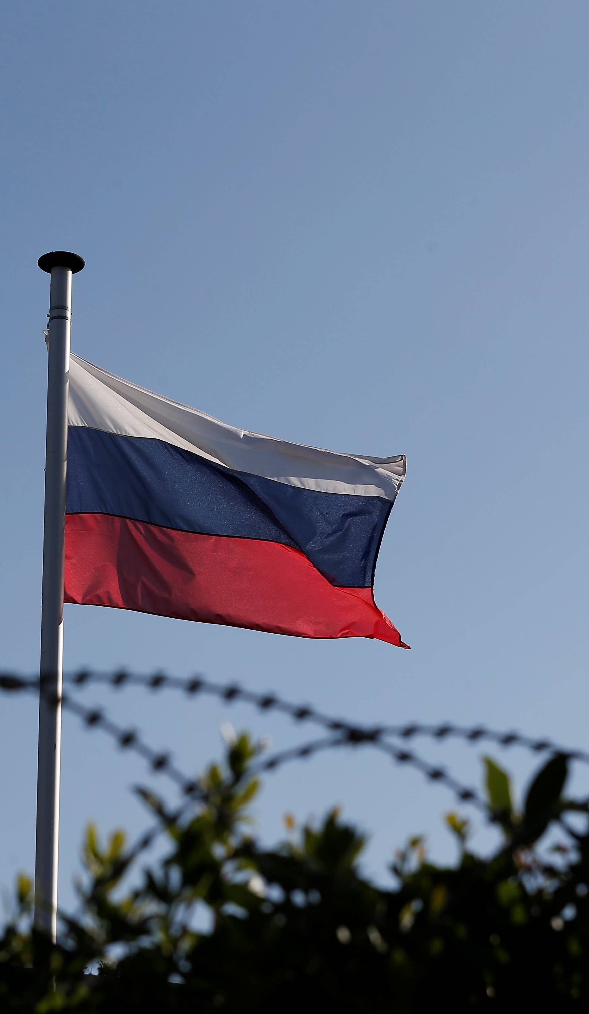 A Russian flag flutters atop the Russian consulate after an explosion, in Athens