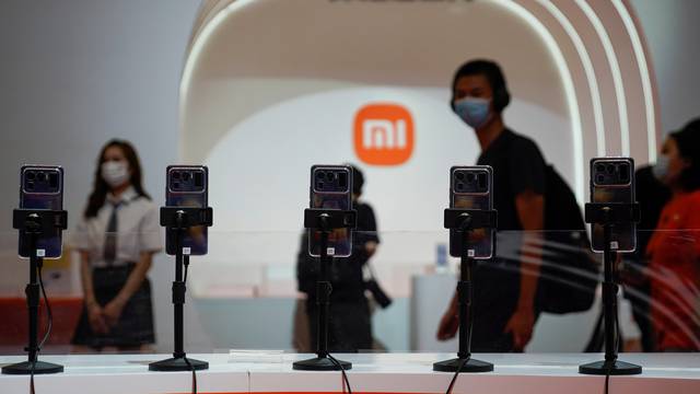 A view of mobile phones in front of the Xiaomi logo at the China Digital Entertainment Expo and Conference, also known as ChinaJoy, in Shanghai