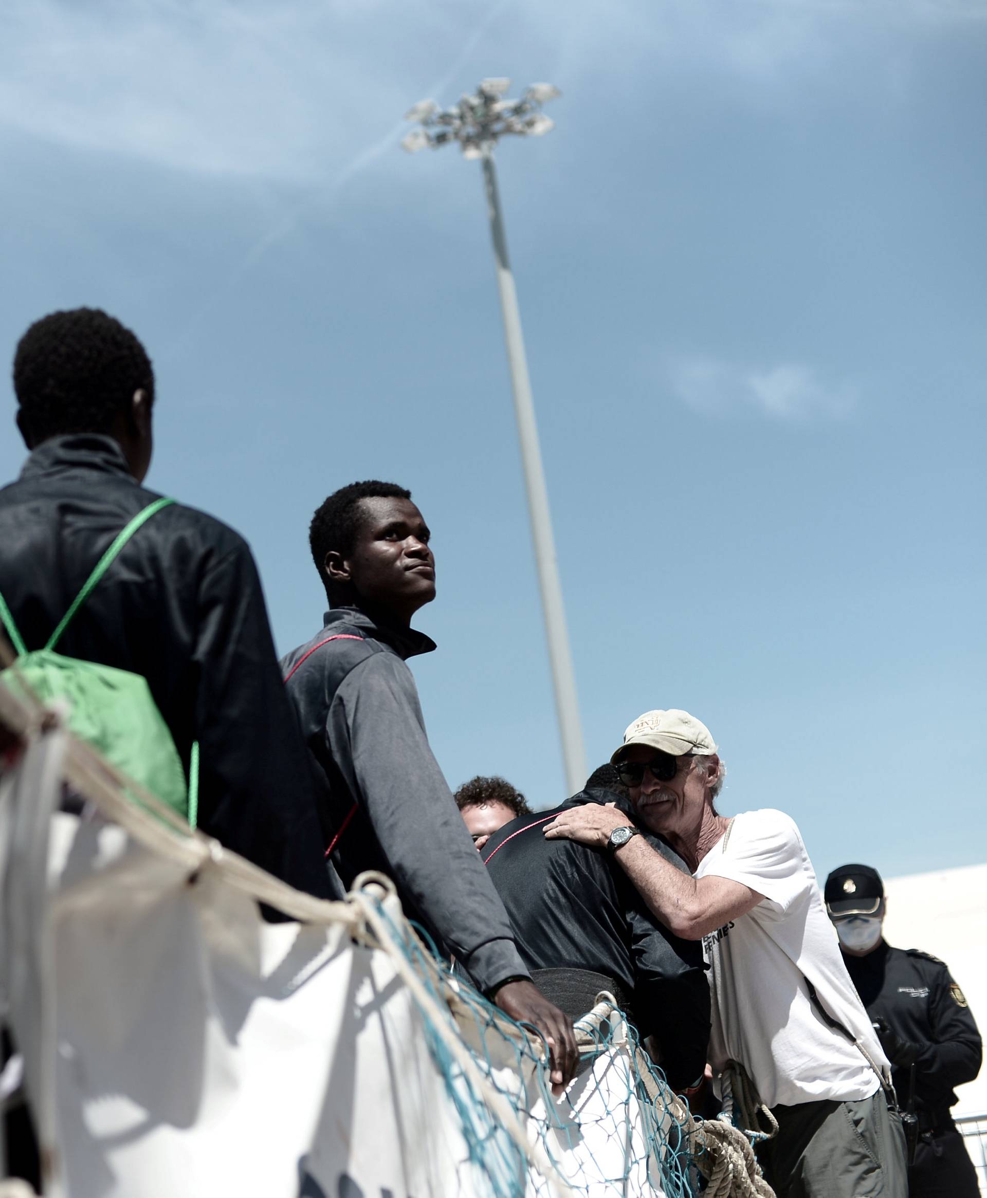 Migrants disembark from the Aquarius rescue ship after arriving to port in Valencia