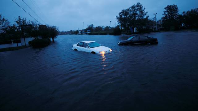 An abandoned car's hazard lights continue to flash as it sits submerged in a rising flood waters after Hurricane Florence struck in Wilmington, North Carolina