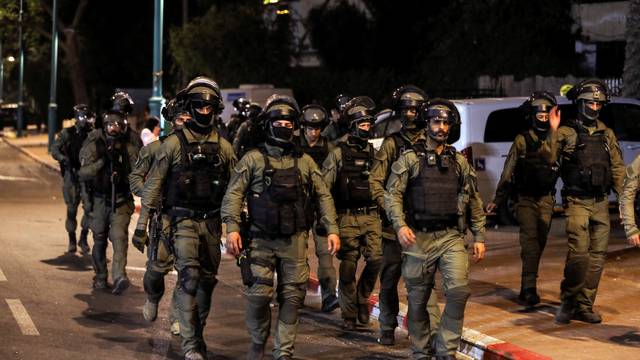Israeli security force members patrol during a night-time curfew following violence in the Arab-Jewish town of Lod