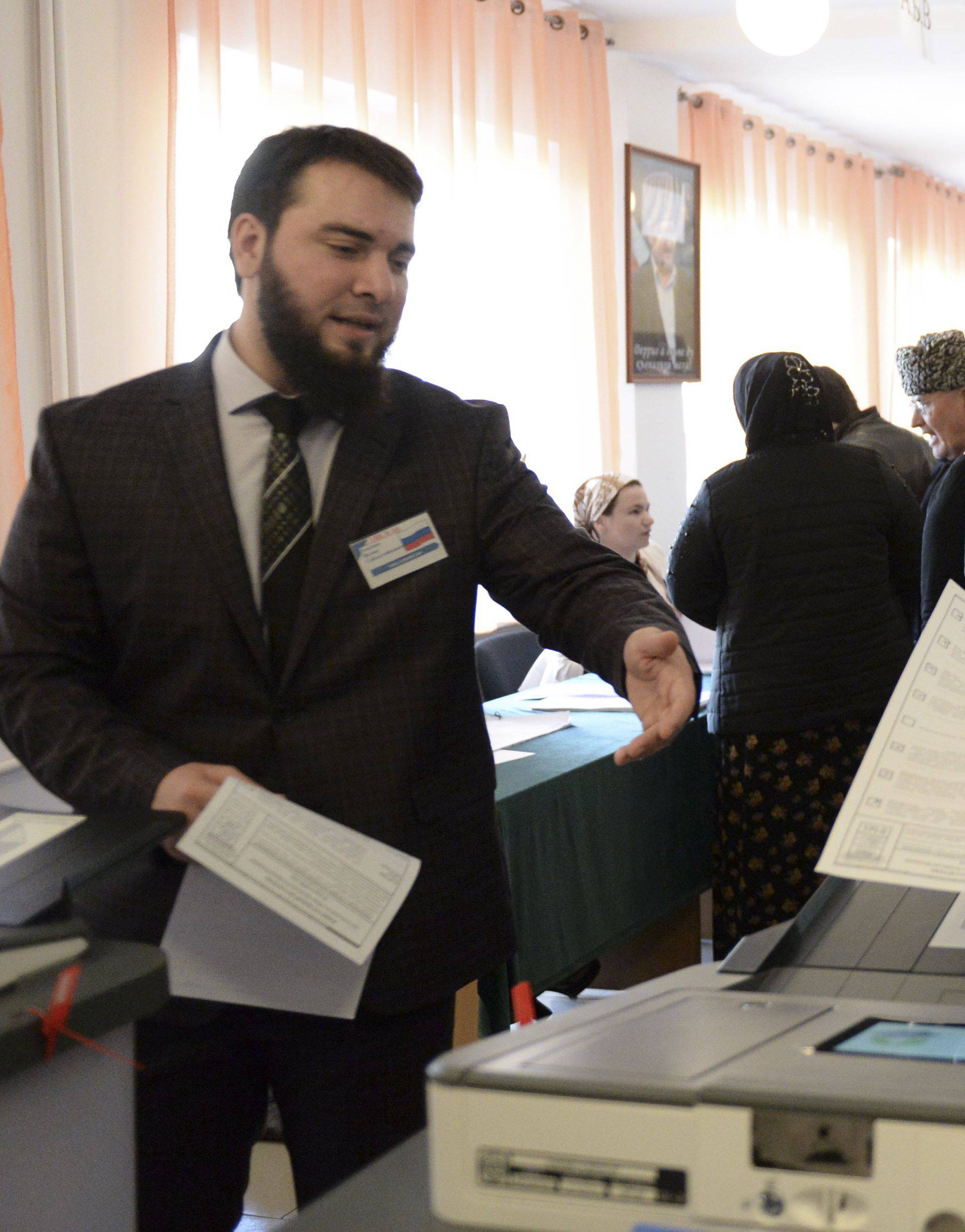 A man casts his vote at a polling station during the presidential election in Tsentoroy