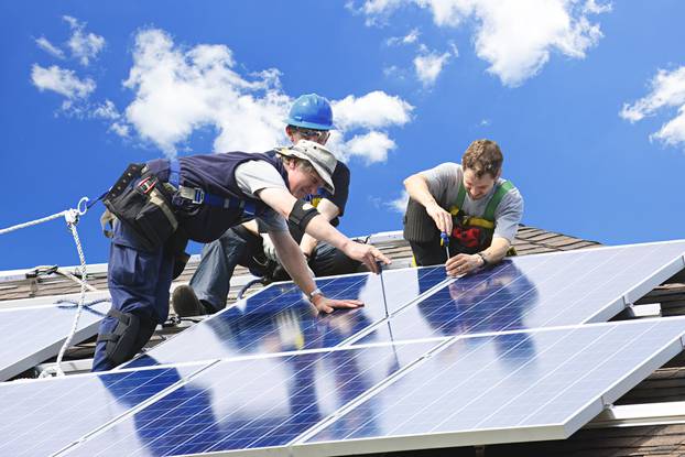 Workers,Installing,Alternative,Energy,Photovoltaic,Solar,Panels,On,Roof
