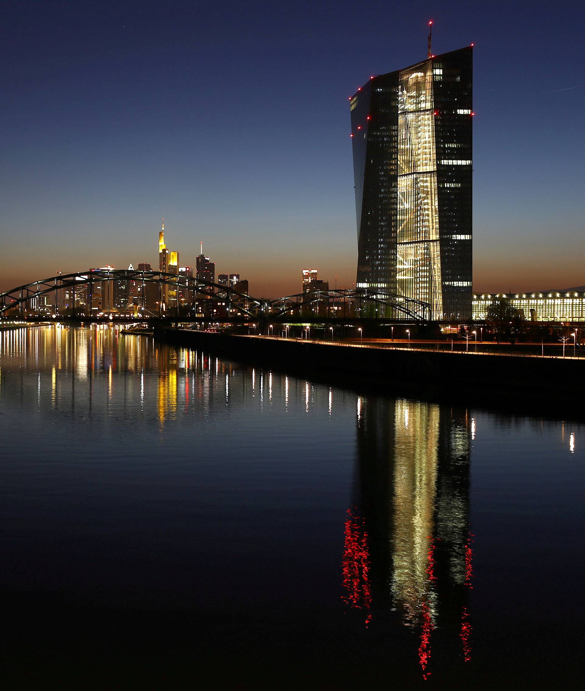 FILE PHOTO: The headquarters of the European Central Bank (ECB) (R) is seen next to the famous skyline in Frankfurt