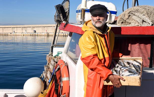 Fisherman,With,A,Fish,Box,Inside,A,Fishing,Boat