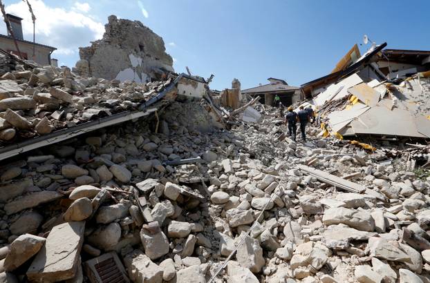 FILE PHOTO: Rescuers work on collapsed buildings following an earthquake in Amatrice