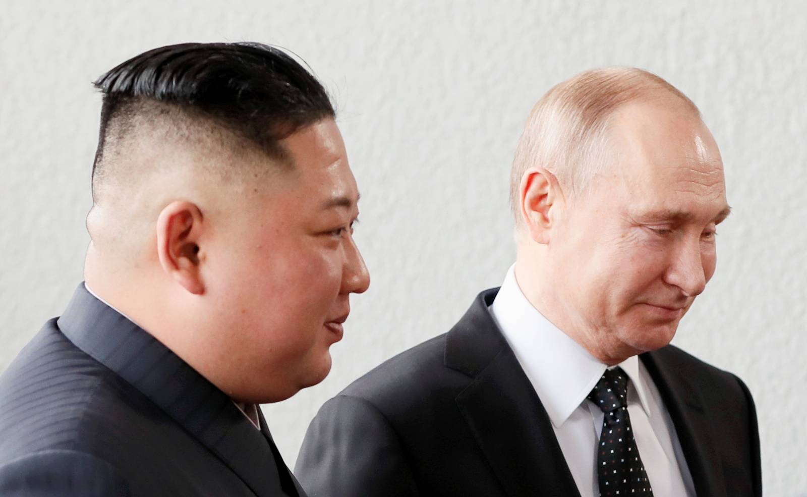 Russia's President Vladimir Putin walks with North Korean leader Kim Jong Un at the Far Eastern Federal University campus at Russky Island in the far eastern city of Vladivostok