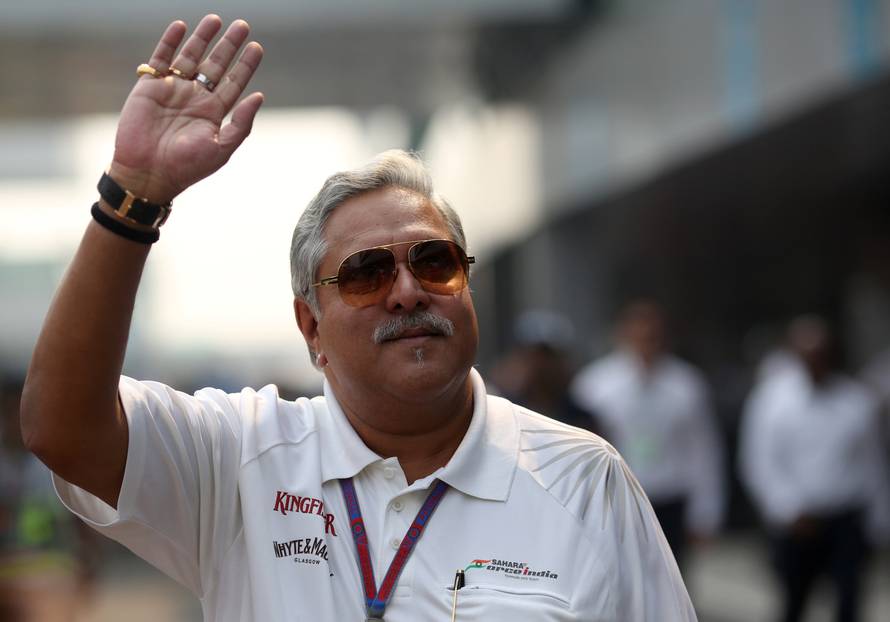 FILE PHOTO: Force India team principal Vijay Mallya waves in the paddock during the third practice session of the Indian F1 Grand Prix at the Buddh International Circuit in Greater Noida
