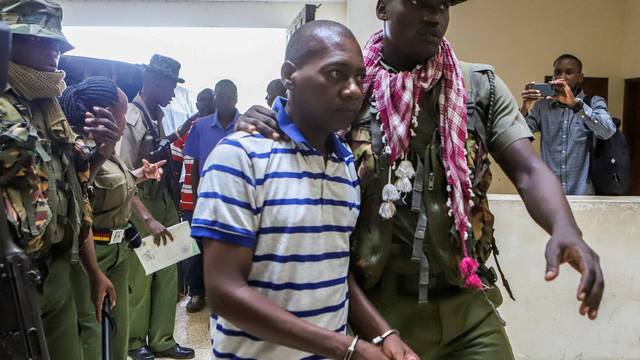 FILE PHOTO: Paul Mackenzie, a Kenyan cult leader accused of ordering his followers, who were members of the Good News International Church, to starve themselves to death in Shakahola forest, is escorted to the Malindi Law Courts