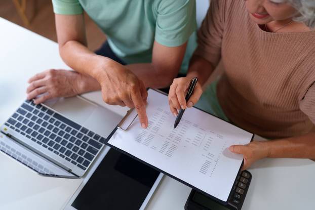 An,Older,Asian,Couple,Reviews,Finances,At,Home,Using,A