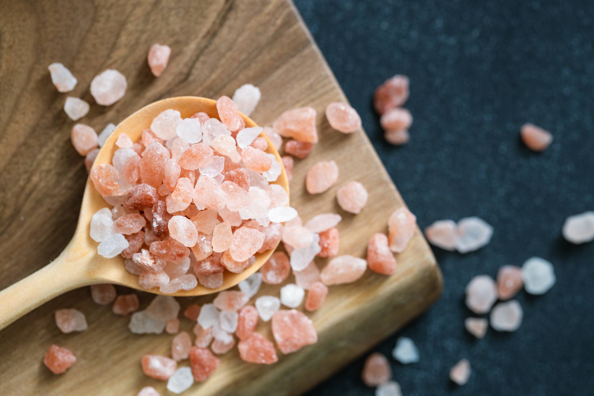 Pink Himalayan salt in wooden spoon.