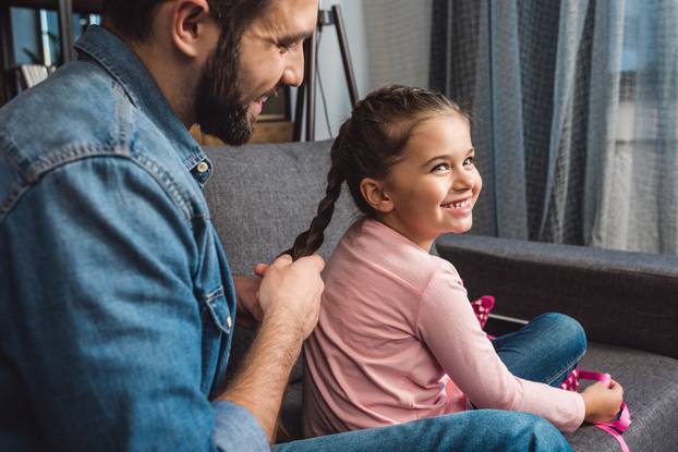 Happy,Father,Making,Hair,Braid,For,Daughter,While,Sitting,On