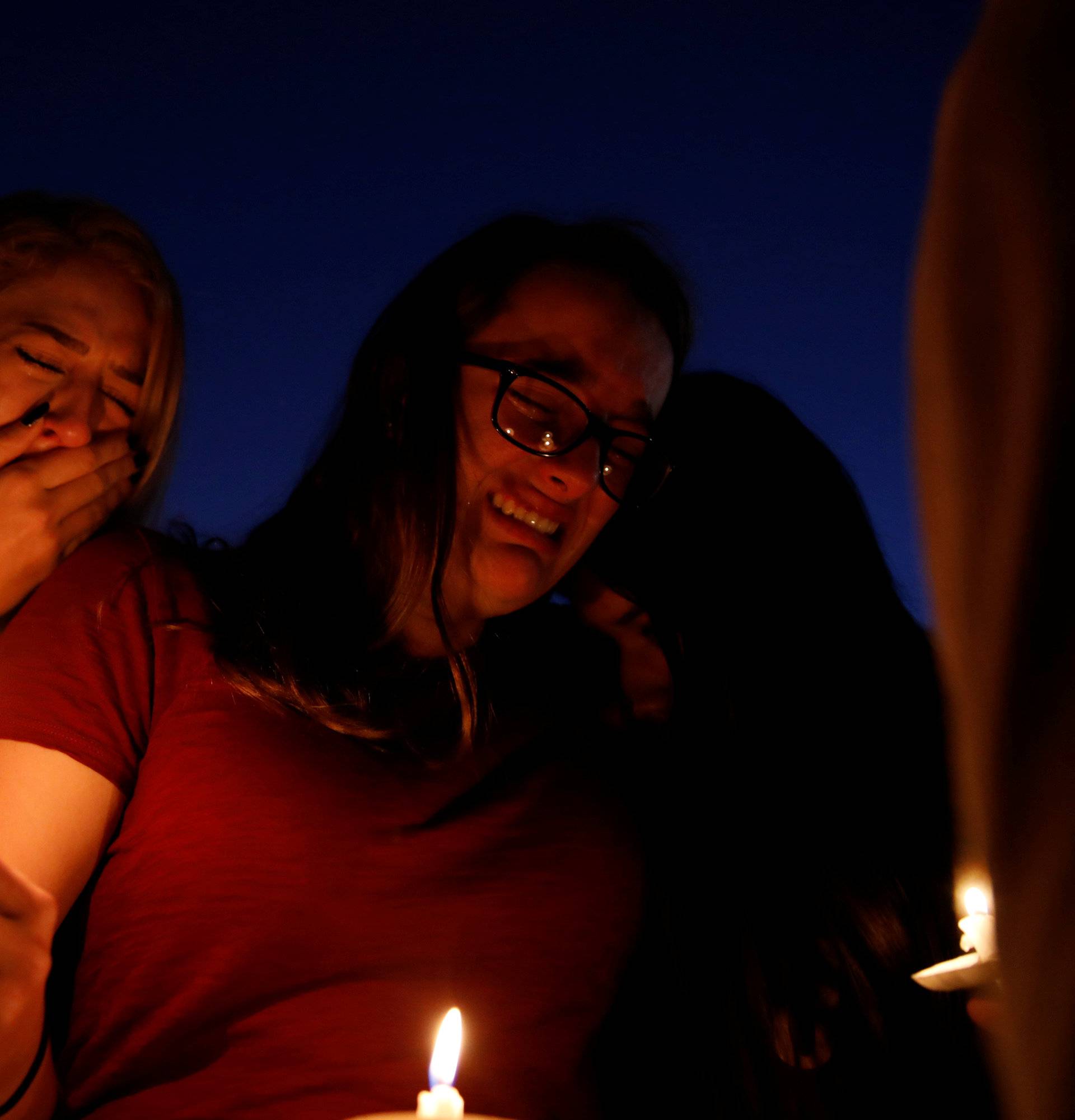 Students mourn during a candlelight vigil for victims of yesterday's shooting at nearby Marjory Stoneman Douglas High School, in Parkland
