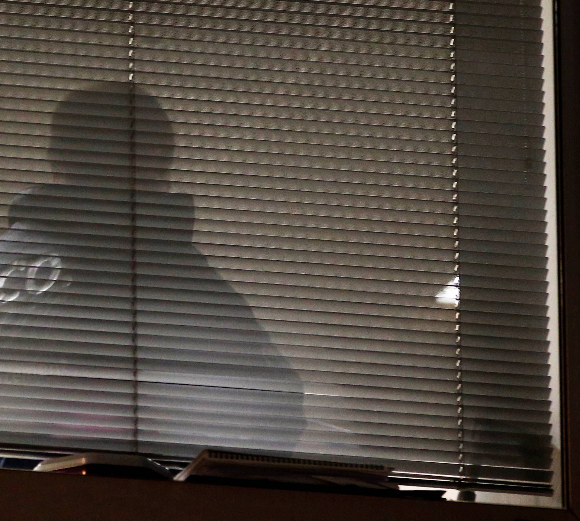 A person is seen inside the building which houses the offices of Cambridge Analytica as investigators from Britain's Information Commissioners Office entered, following the granting of a search warrant by a High Court judge, in London