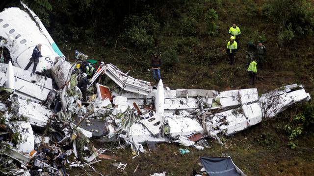 Rescue crew work in the wreckage from a plane that crashed into Colombian jungle with Brazilian soccer team Chapecoense near Medellin