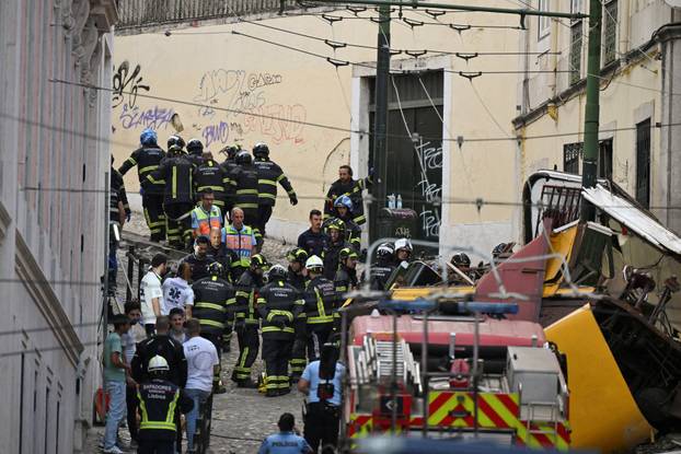 First responders work at the site of a funicular accident in Lisbon