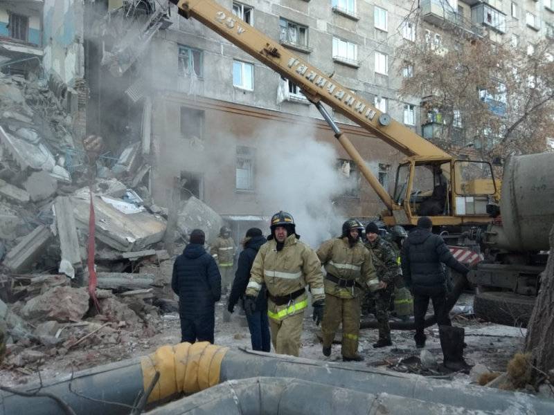 Emergency personnel work at the site of collapsed apartment building after a suspected gas blast in Magnitogorsk