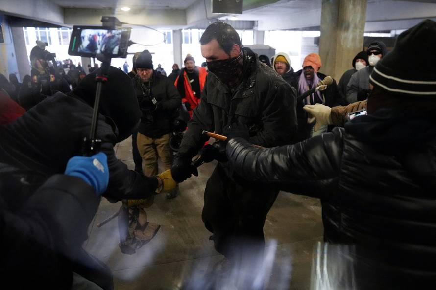 People attend the "March Against Minnesota Fraud" in Minneapolis