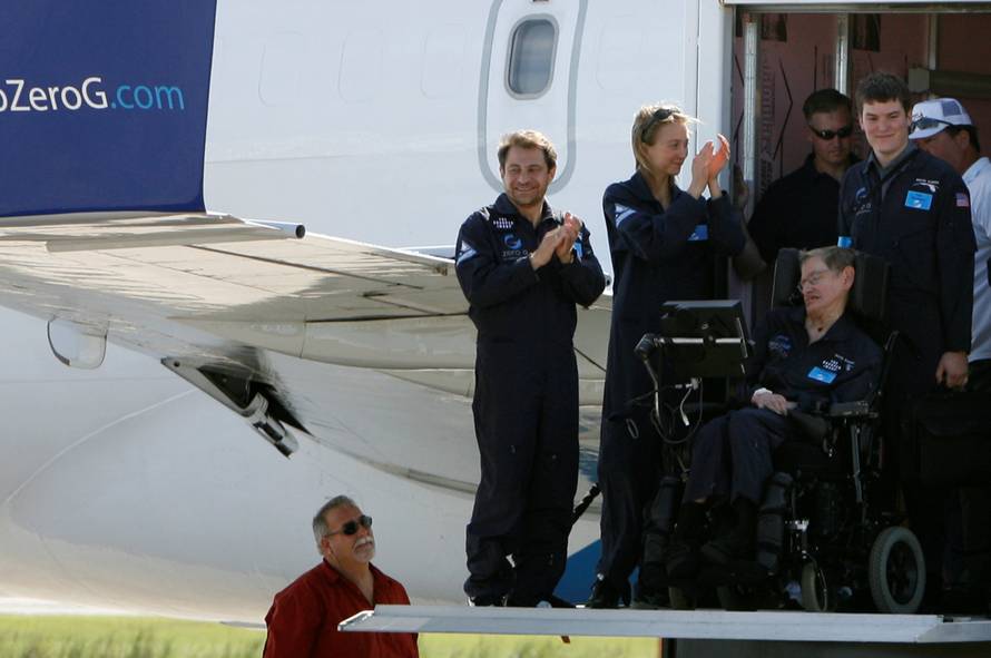 FILE PHOTO: CEO of ZERO-G Peter Diamandis (L) and crew with Professor Stephen Hawking, the world renowned physicist and expert on gravity on a lift truck after his flight at  Kennedy Space Center in Cape Canaveral, Florida