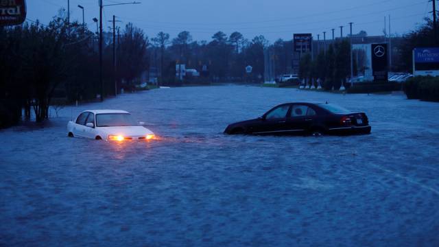 An abandoned car's hazard lights continue to flash as it sits submerged in a rising flood waters after Hurricane Florence struck in Wilmington, North Carolina