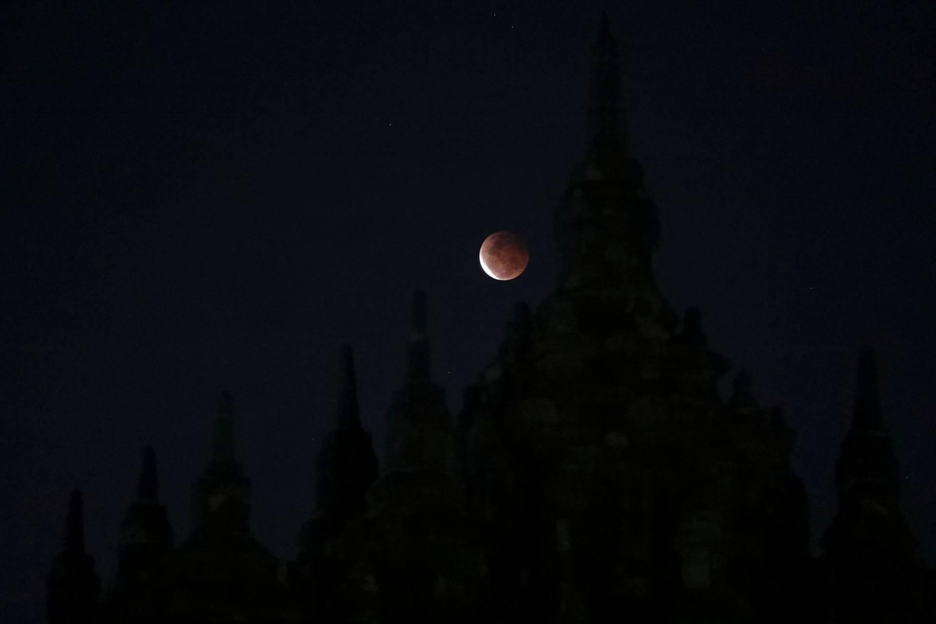 A Super Blood Moon rises over the Plaosan temple during total lunar eclipse in Klaten