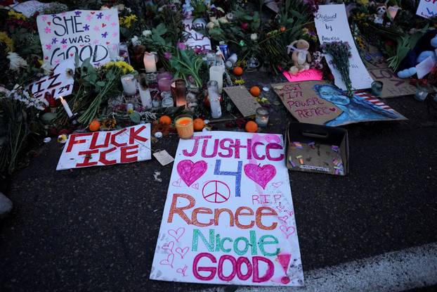 FILE PHOTO: People visit a makeshift memorial at the site of the fatal shooting of Renee Nicole Good by a U.S. Immigration and Customs Enforcement (ICE) agent, in Minneapolis