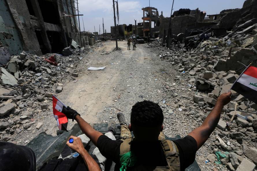 Members of the Emergency Response Division celebrate in the Old City of Mosul