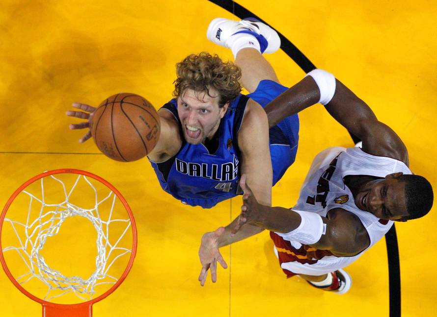 File Photo Dallas Mavericks' Nowitzki of Germany shoots past Miami Heat's Bosh during the first half in Game 1 of the NBA Finals in Miami