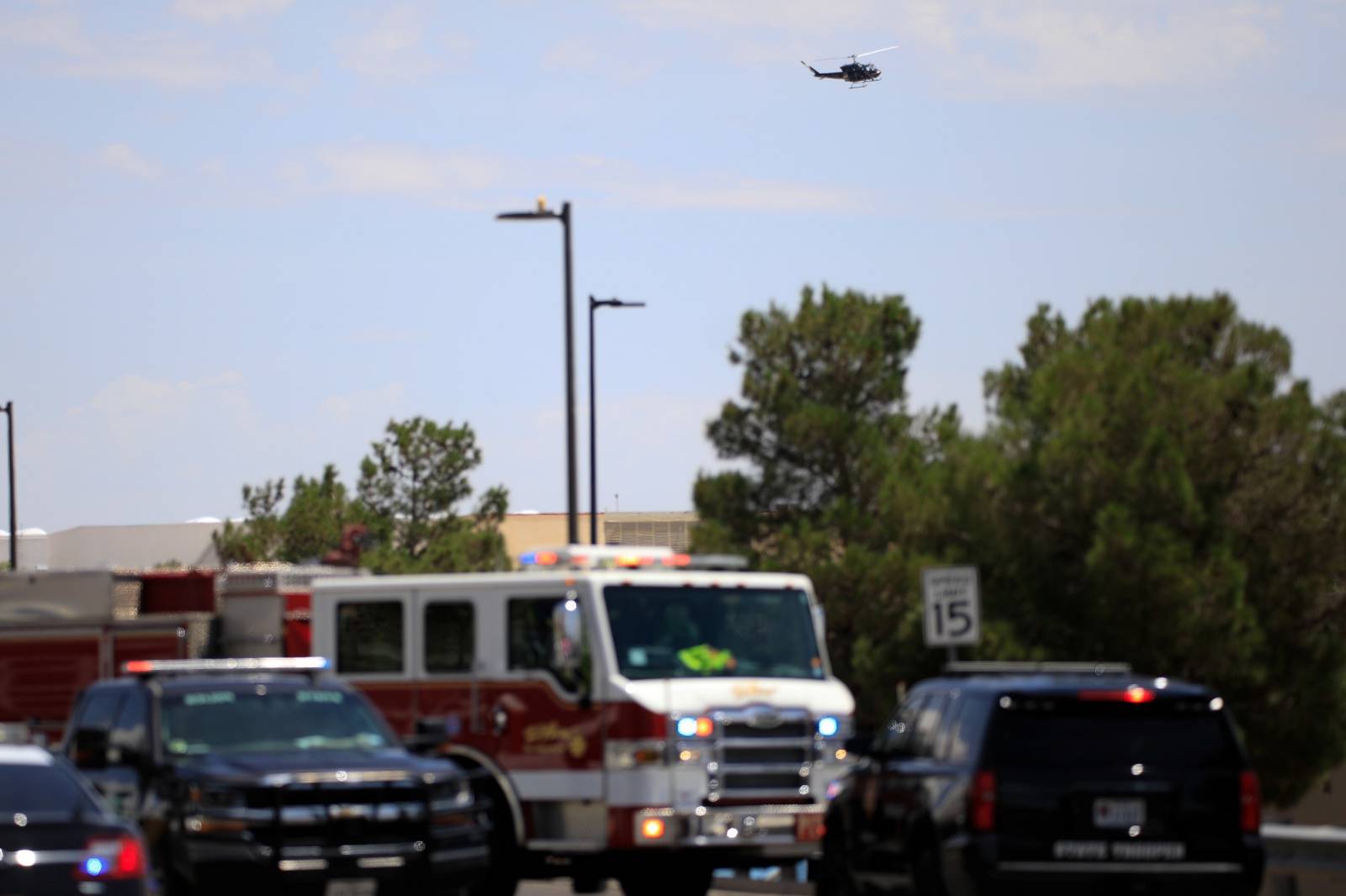 A police helicopter circles the area after a mass shooting at a Walmart in El Paso