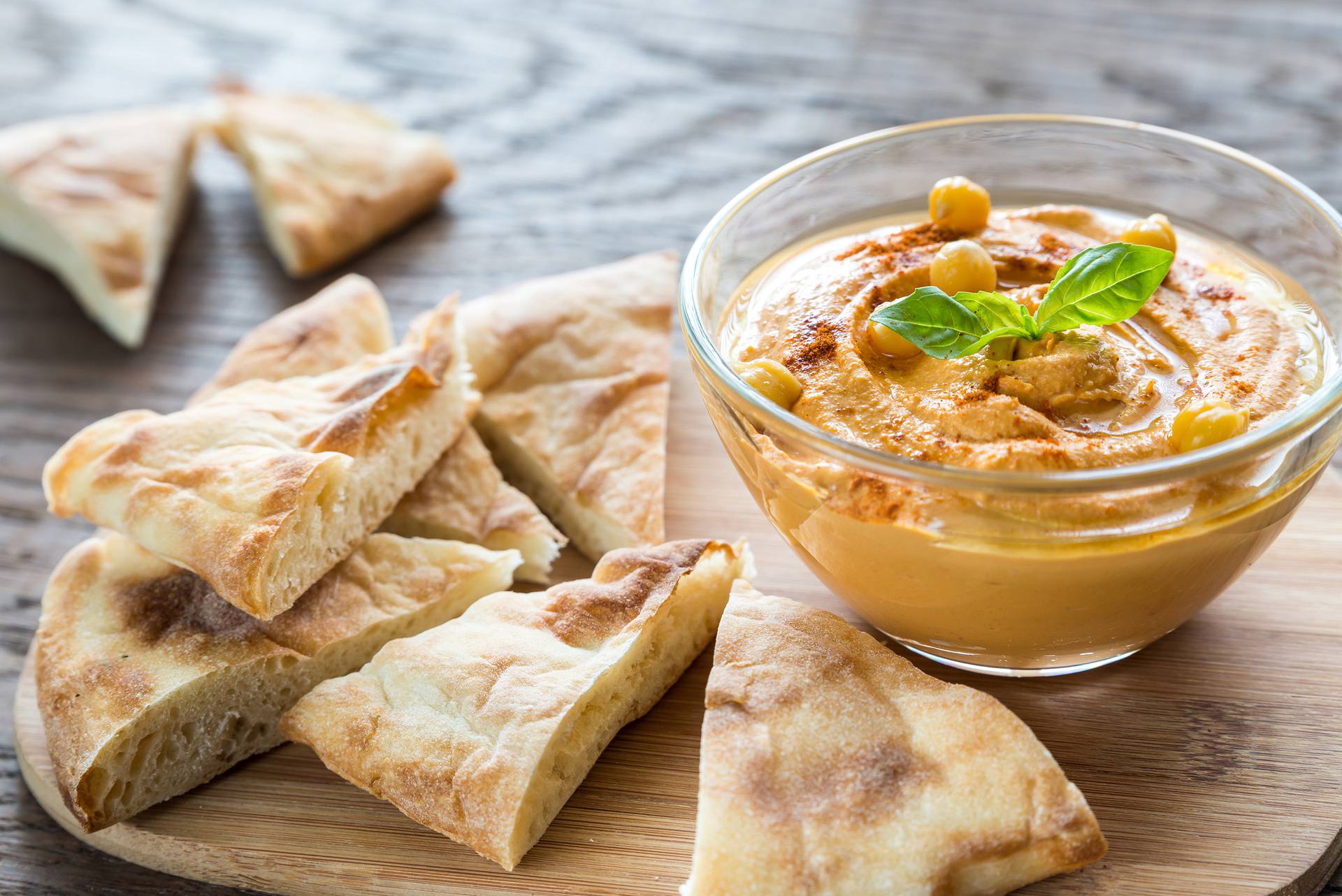 Bowl of hummus with pita slices