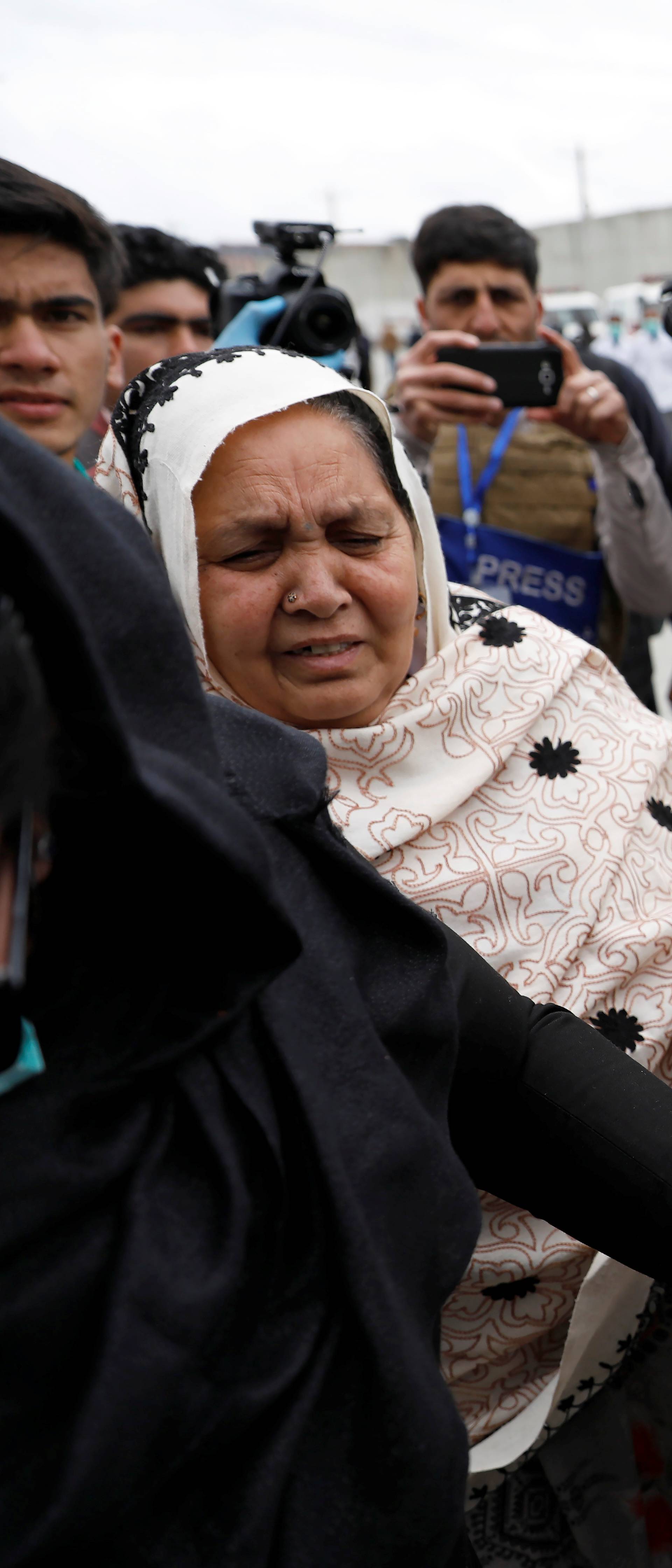 An Afghan Sikh woman mourns for her relatives near the site of an attack in Kabul