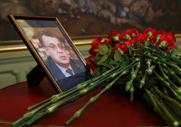 Flowers are placed near a portrait of murdered Russian ambassador to Turkey Karlov during a meeting of Russian Foreign Minister Lavrov with his Turkish counterpart Cavusoglu in Moscow
