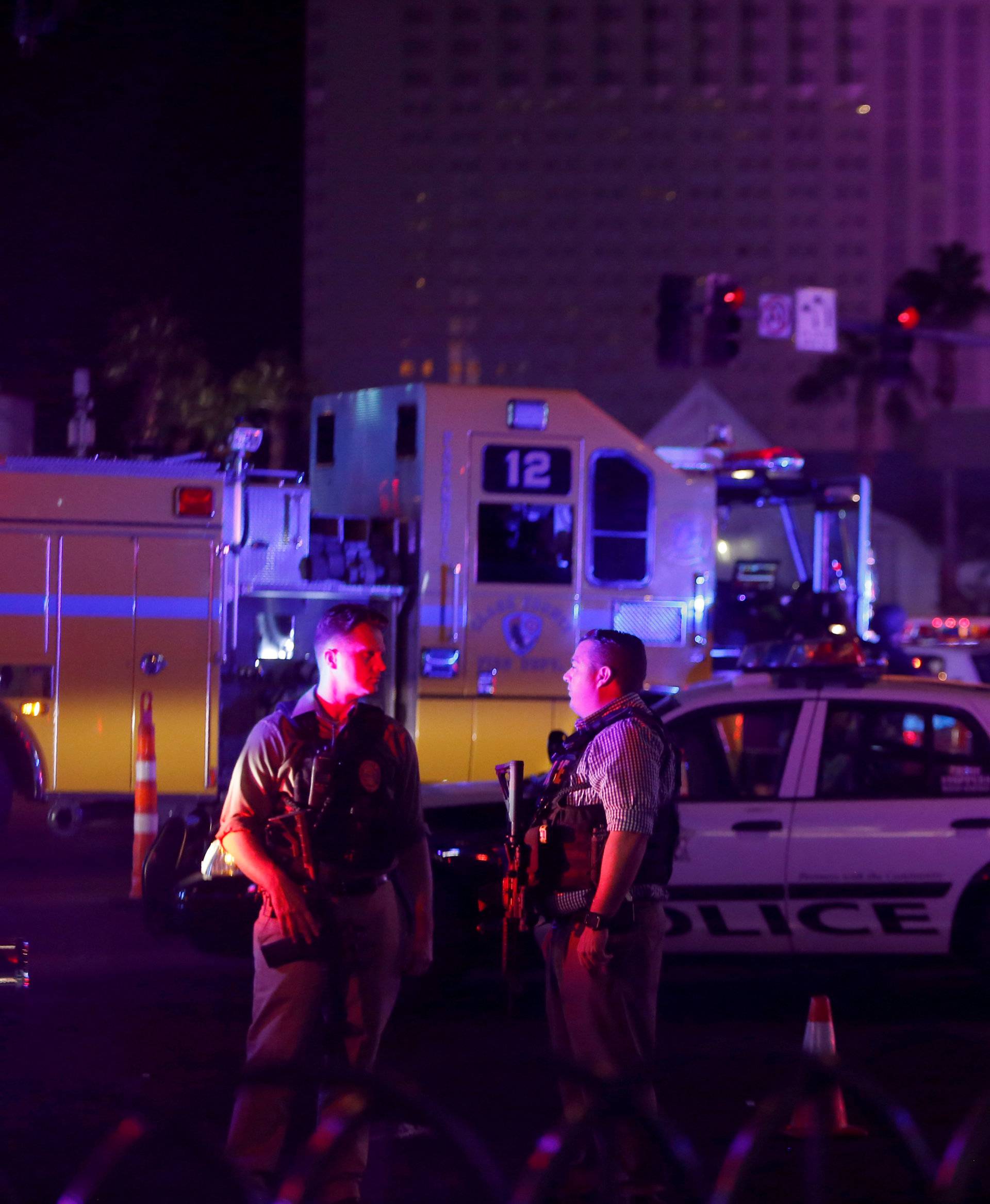 Las Vegas Metro Police officers confer near a staging area in the intersection of Tropicana Avenue and Las Vegas Boulevard South after a mass shooting at a music festival on the Las Vegas Strip in Las Vegas