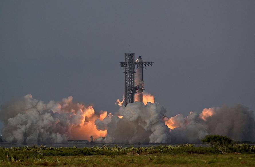 A SpaceX Super Heavy booster carrying the Starship spacecraft lifts off on its 10th test flight