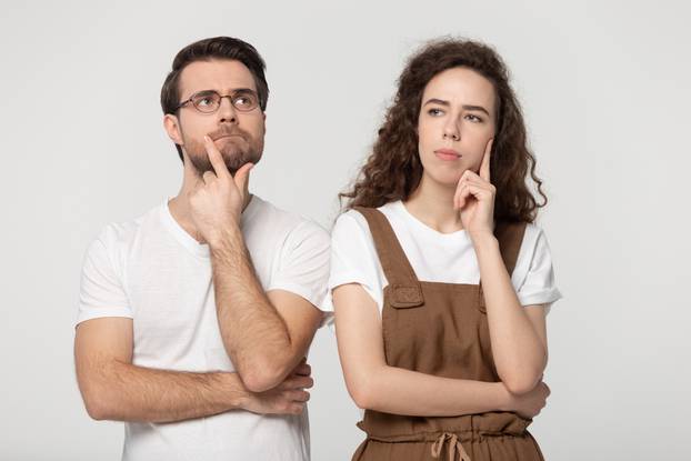 Thinking,Millennial,Couple,Pose,Isolated,On,Grey,Studio,Background,,Pretty