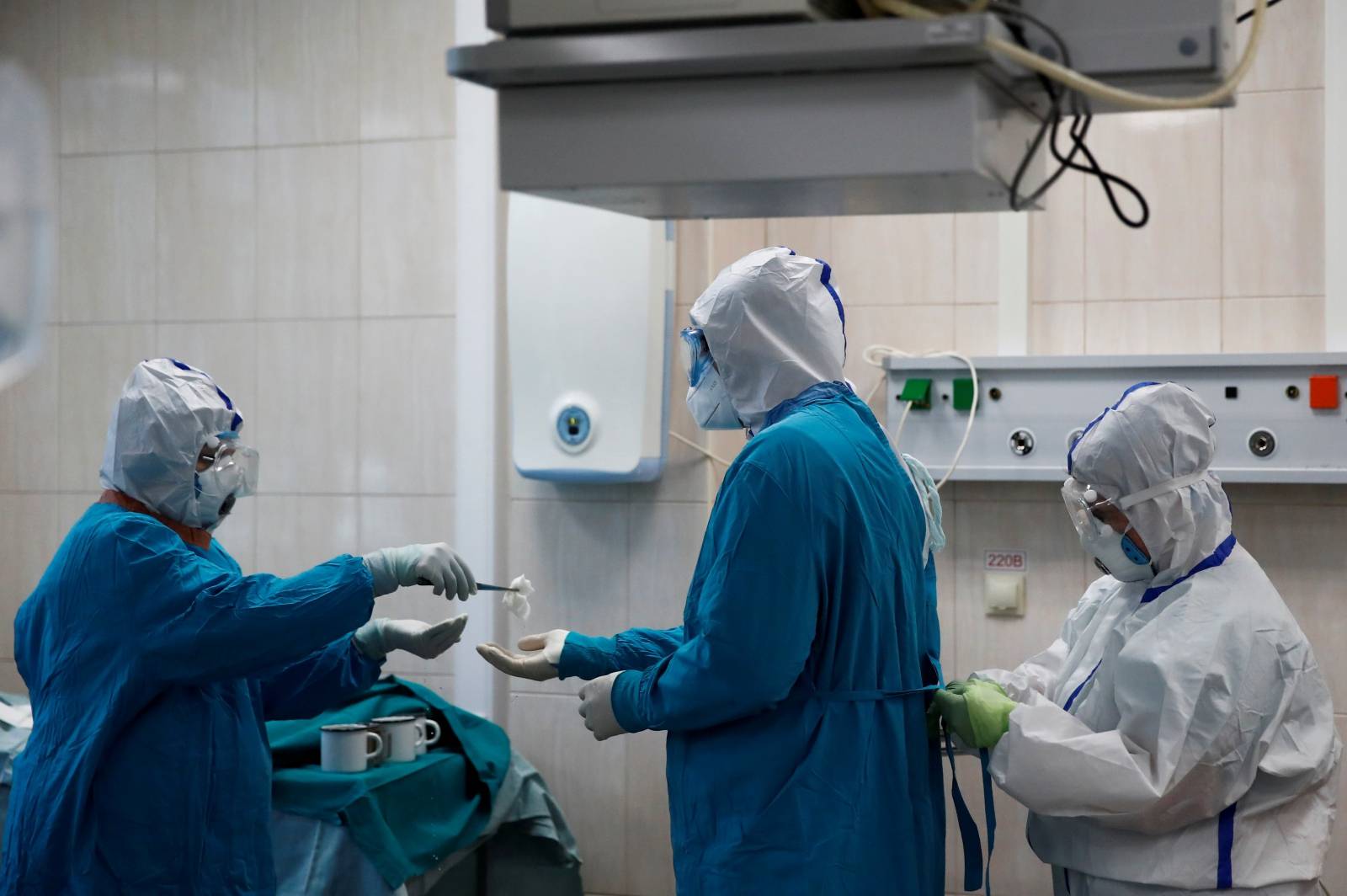 Medical specialists perform emergency surgery on a patient infected with the coronavirus disease in a hospital in Moscow