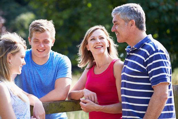 Family With Teenage Children Walking In Countryside
