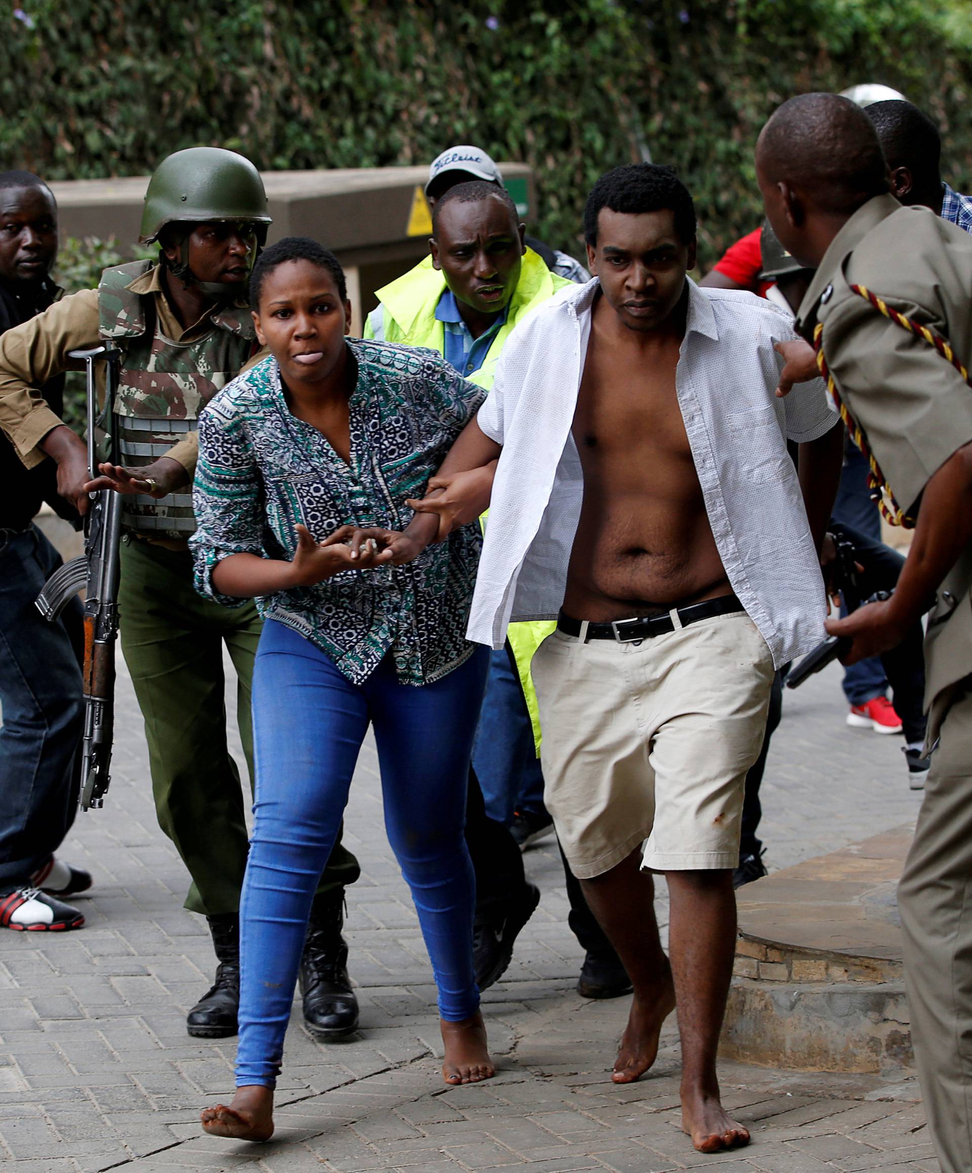 People are evacuated at the scene where explosions and gunshots were heard at the Dusit hotel compound, in Nairobi