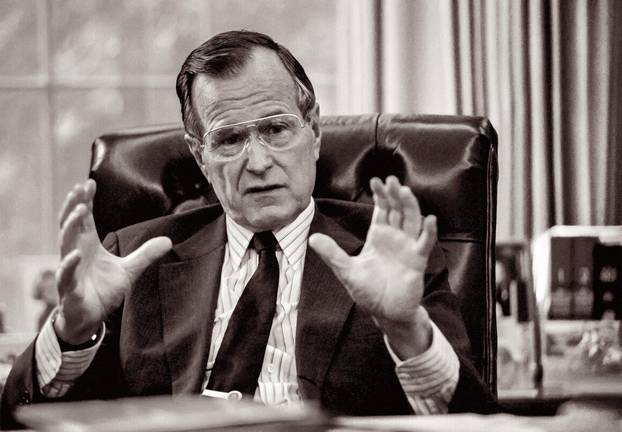 President George H.W. Bush at his desk in the Oval Office of the White House in 1989. (Photo by Michael Geissinger.)