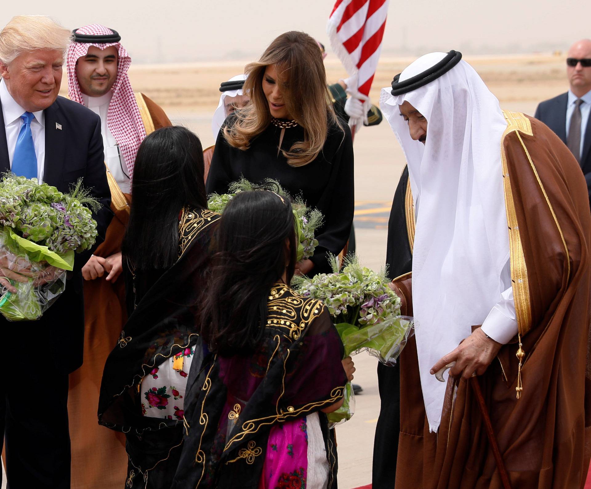 Saudi Arabia's King Salman, Trump and the first lady are greeted with flowers by children in an arrival ceremony at King Khalid Airport in Riyadh