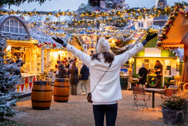 A,Happy,Tourist,Woman,Stands,On,A,Christmas,Market,In