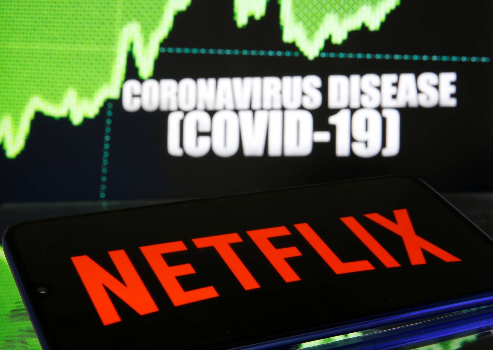 Netlix logo is seen in front of diplayed coronavirus disease (COVID-19)