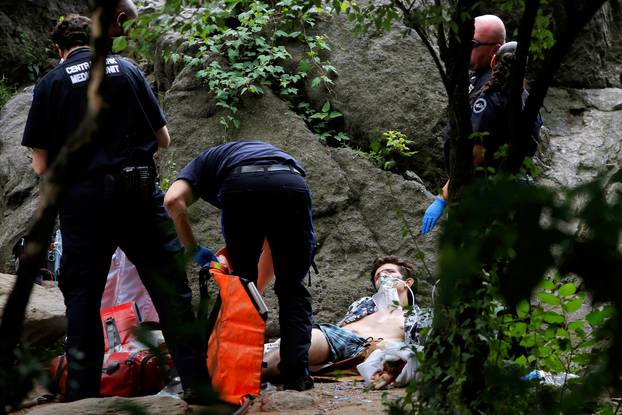 Medics stand over a man after an explosion in Central Park, Manhattan, New York
