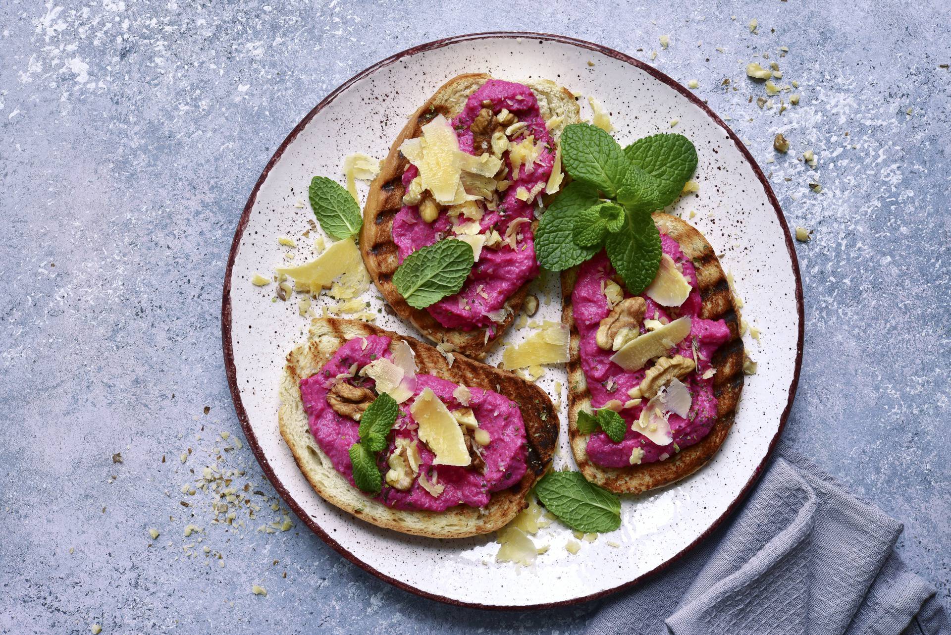 Toasts with beetroot paste, parmesan cheese, walnut and mint