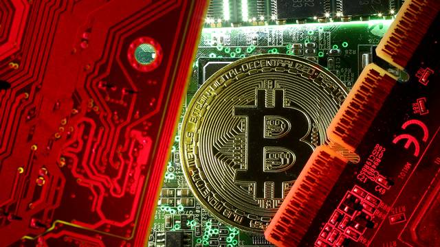 FILE PHOTO: A copy of bitcoin standing on PC motherboard is seen in this illustration picture